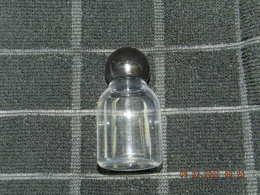 Lot 46 Clear plastic 1oz bell shaped bottle with round black ball top