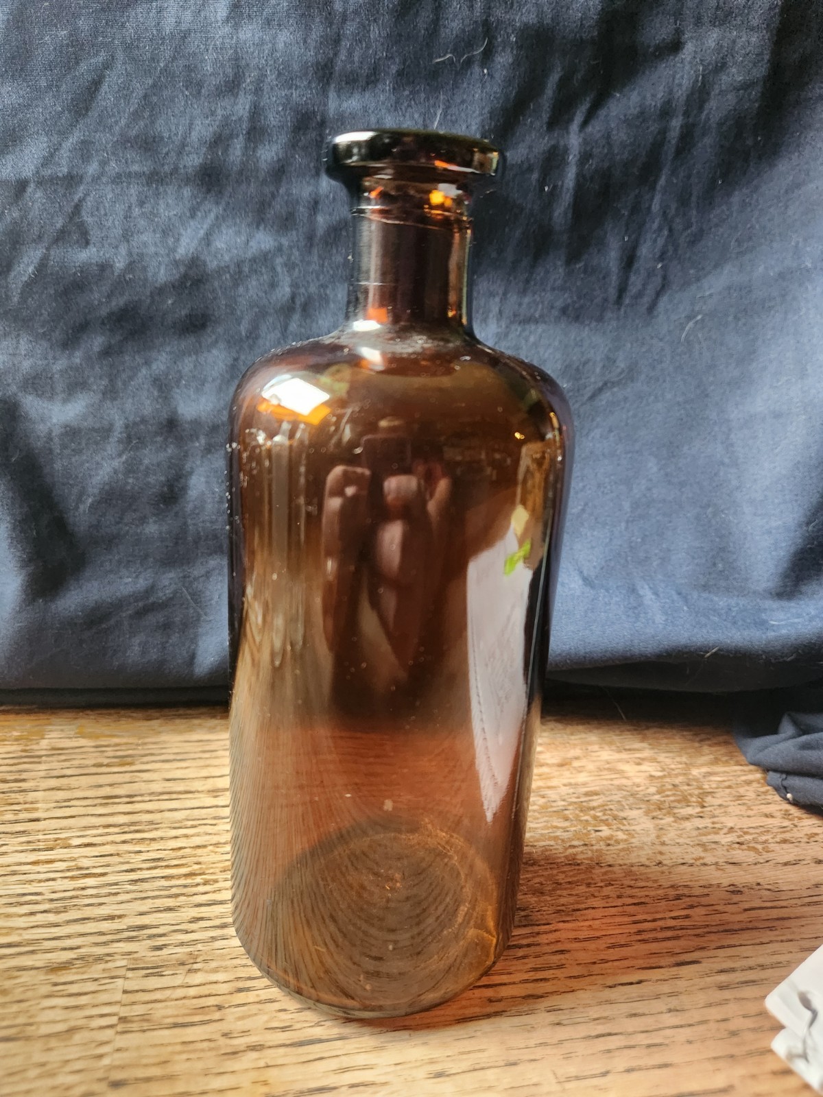 Amber glass Apothecary bottle 7 3/4 inches tall and 3 inches in diameter w/o cor
