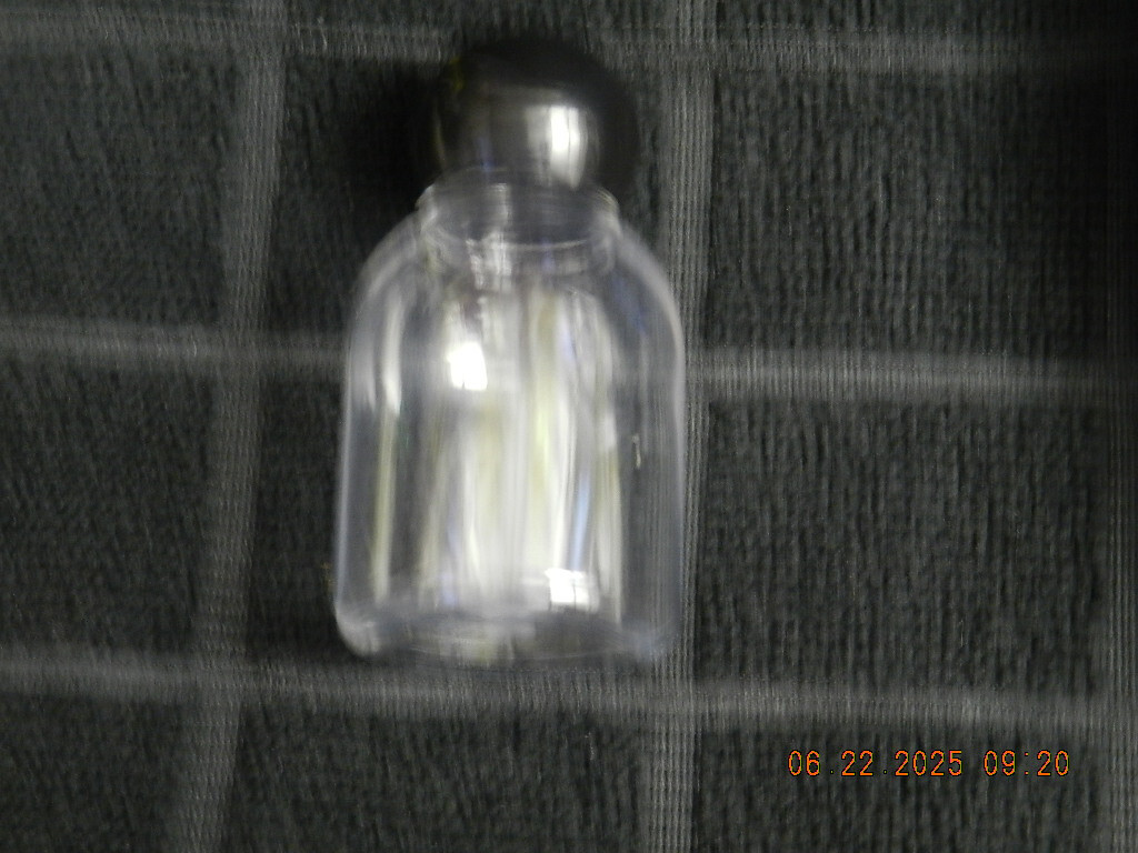 Lot 46 Clear plastic 1oz bell shaped bottle with round black ball top