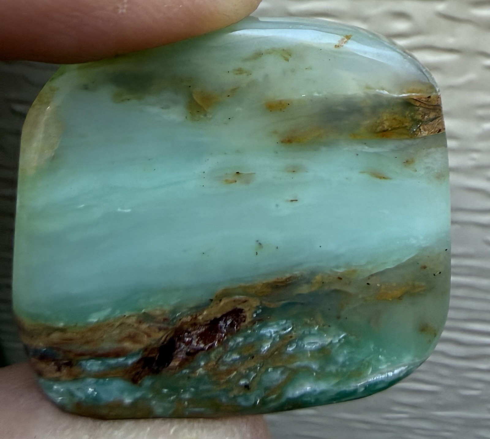 Peruvian Opal Cabochon. 1 1/4” x 1 3/16” x 1/4”, 0.3 oz. Polished all sides.