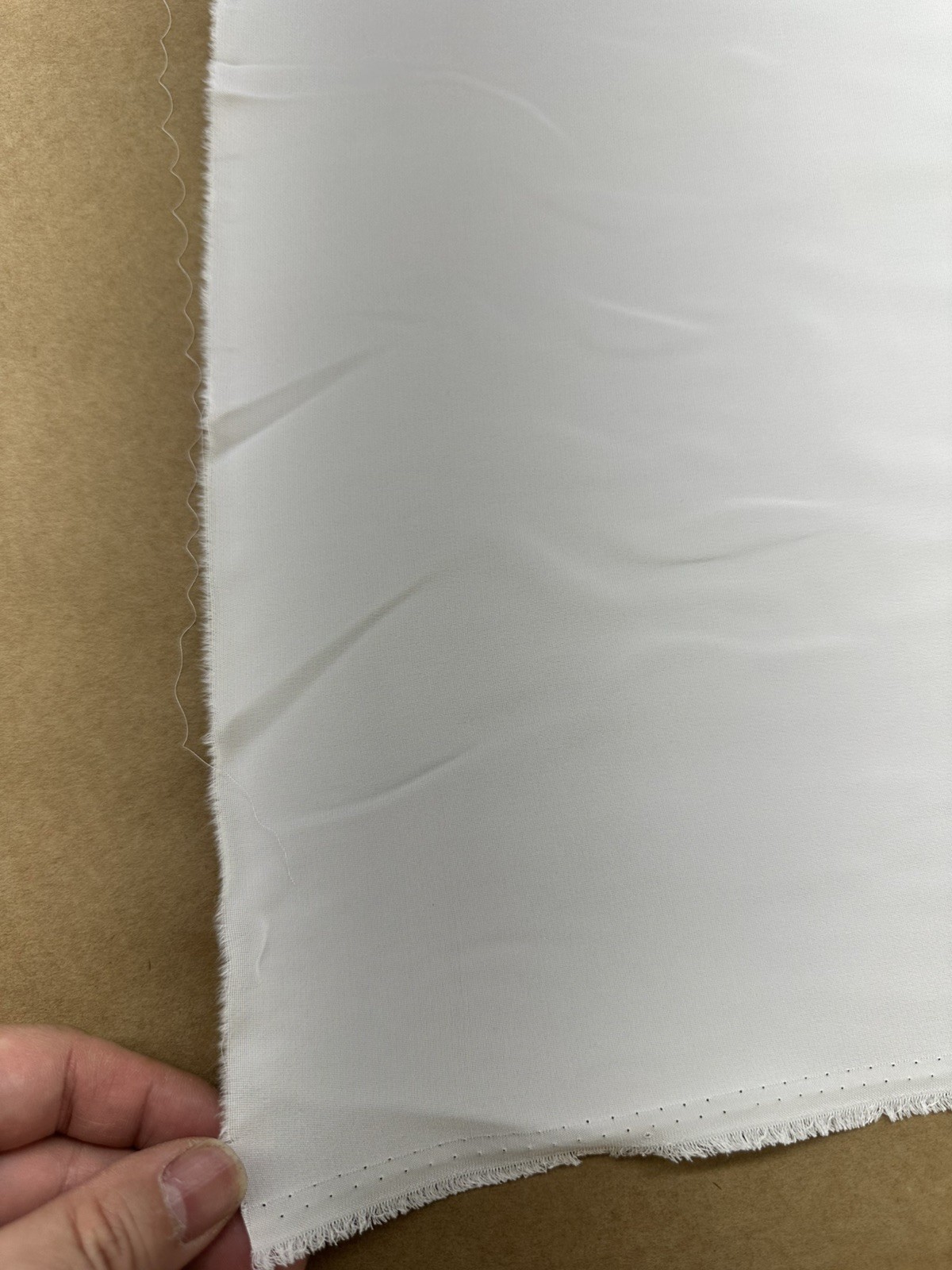 100% Silk heavy crepe , light Ivory color, 55”W, sold by yard