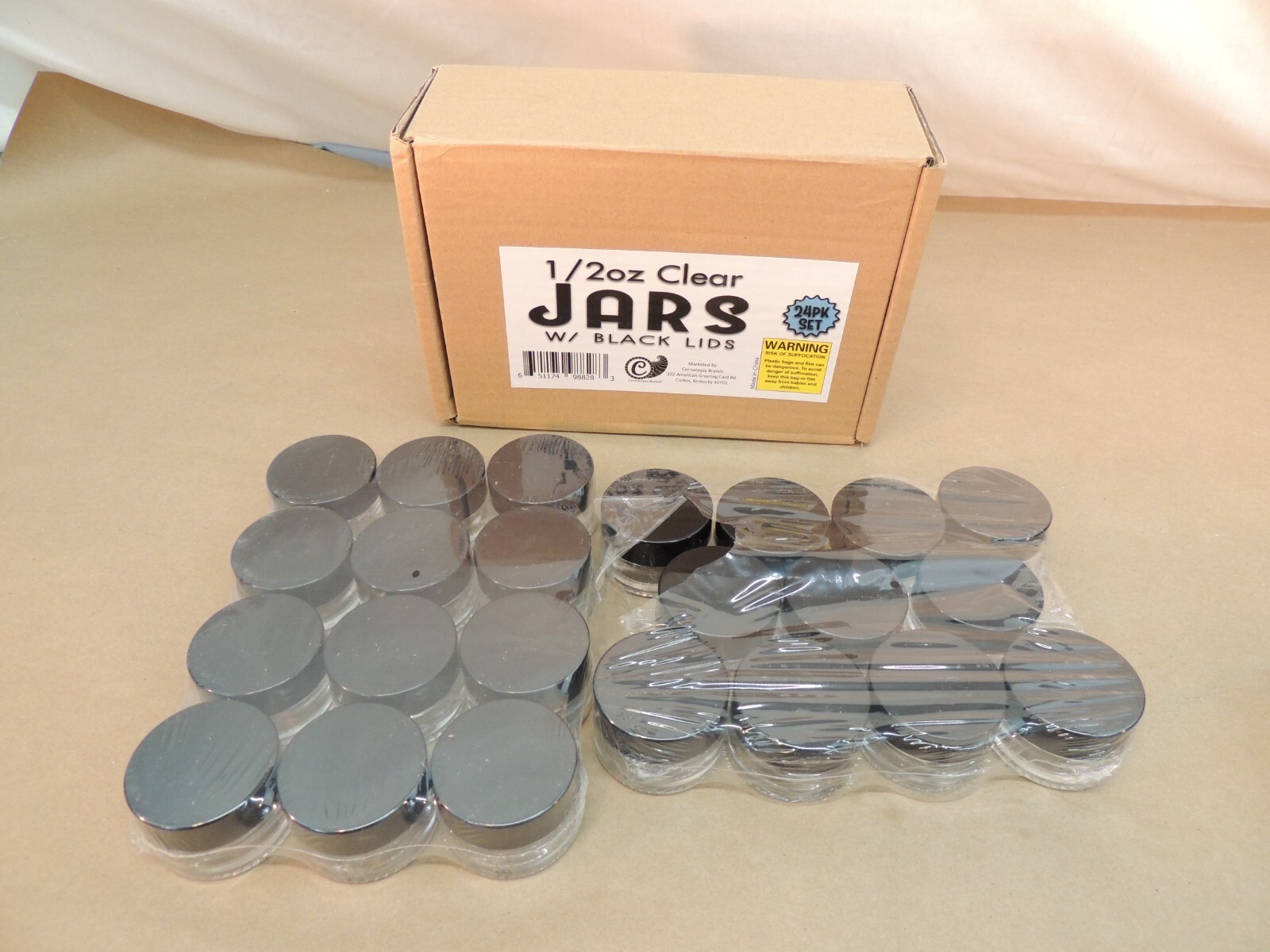 1/2 OZ, HALF OUNCE, CLEAR JARS WITH BLACK LIDS, OPENED BOX, 23 JARS REMAINING