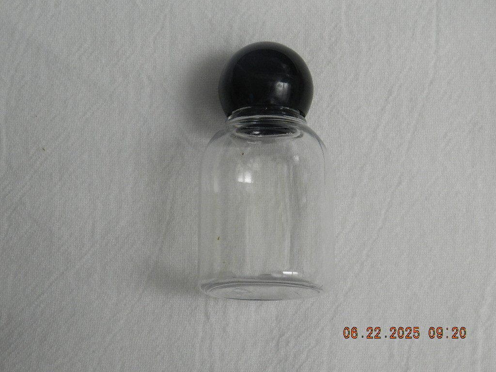 Lot 46 Clear plastic 1oz bell shaped bottle with round black ball top