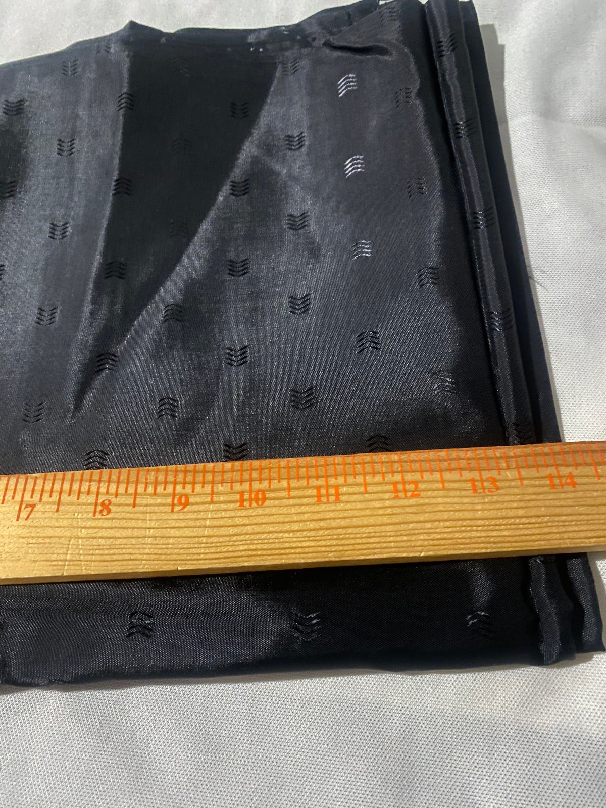 Black polyester lining fabric with small arrow embossed design 3 yards x 44″