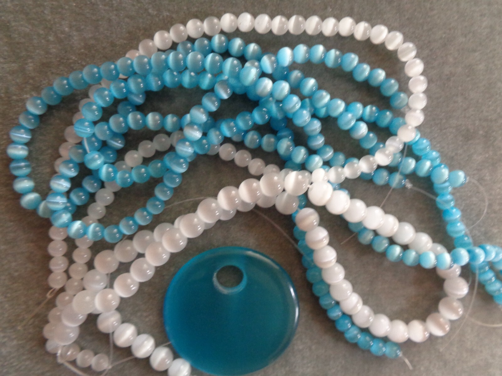 Bead, cat’s eye glass (fiber optic glass), white, 6 &8 mm round, quality grade.