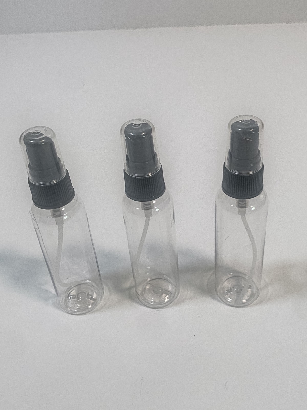 20 clear plastic spray bottles with black spray caps and tubes