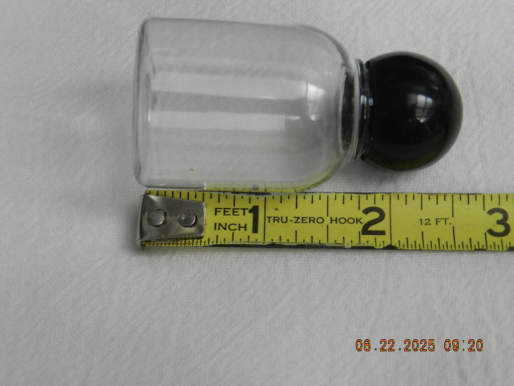 Lot 46 Clear plastic 1oz bell shaped bottle with round black ball top