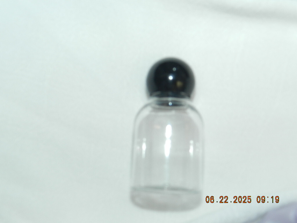Lot 46 Clear plastic 1oz bell shaped bottle with round black ball top