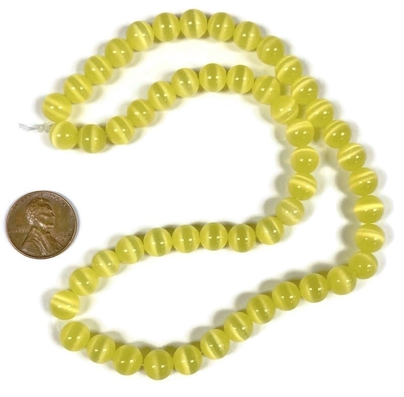 50 Cat’s Eye Fiber Optic Glass Muted Yellow 8mm. Smooth Round Beads 2568
